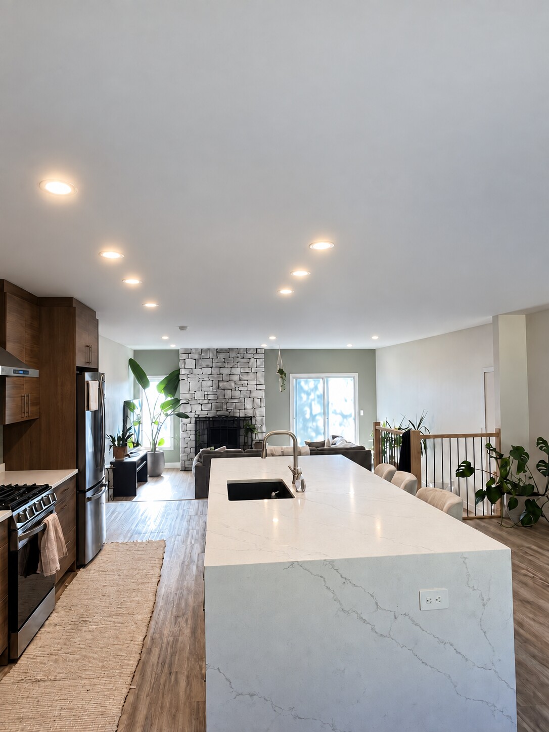 Open-concept kitchen and living area with recessed lighting
